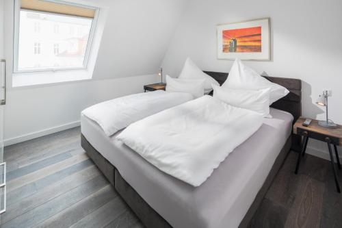 Кровать или кровати в номере Haus Insulaner Tolle 7