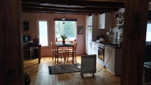 a kitchen and dining room with a table and chairs at Podlaskie Żuczki in Żuki