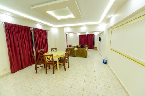 a living room with a table and chairs and a whiteboard at ZAFERO POREFAG- Families only in Alexandria