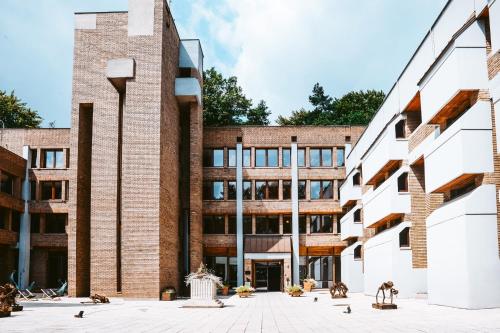an external view of a brick building with a courtyard at Forest Hotel in Kraków