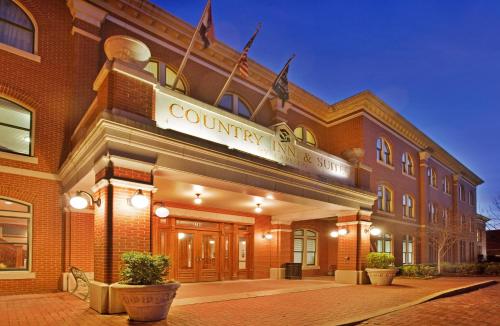 a building with a sign on the front of it at Country Inn & Suites by Radisson, St Charles Historic District in St. Charles