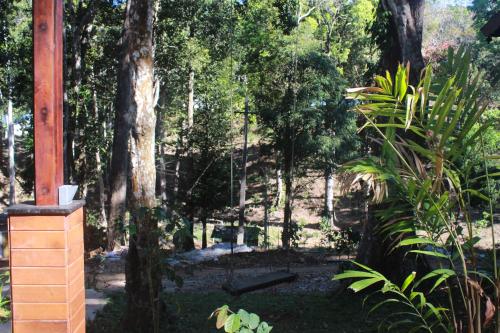 a garden with trees and a swing at VANYA by Citrine in Nelliyampathy
