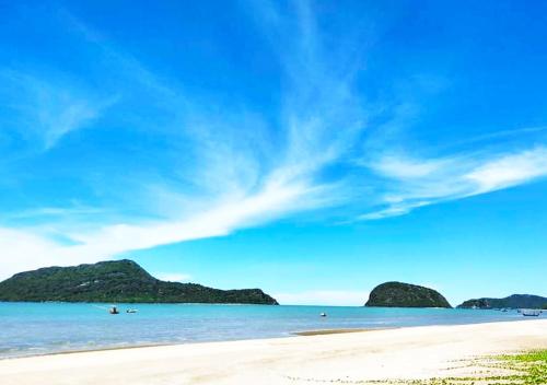 a beach with two islands in the water at Baan Golden Pool Villa in Sam Roi Yot