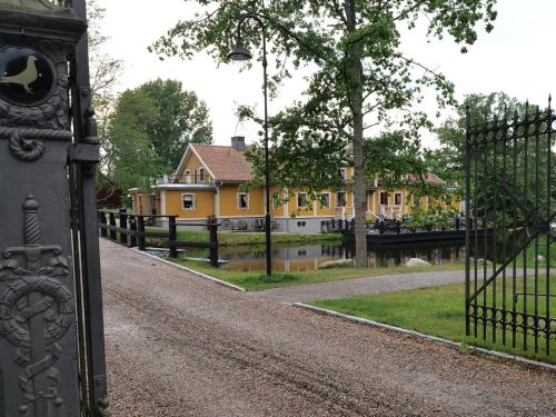 an iron gate with a house in the background at Dufweholms Herrgård in Katrineholm