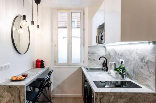 a kitchen with a sink and a counter top at The Design Shelter - Duke Housing in Vitry-sur-Seine
