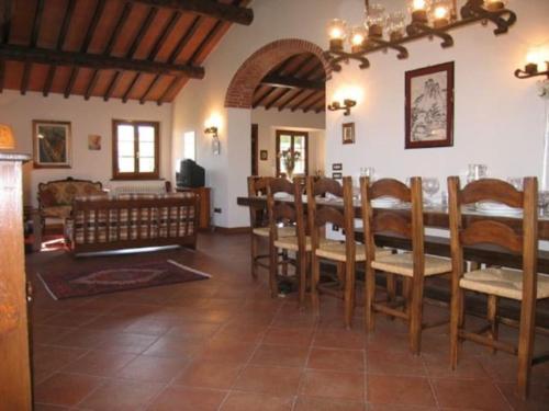 a dining room with a table and chairs at Podere Belvedere - Villa with private swimming-pool in Carmignano