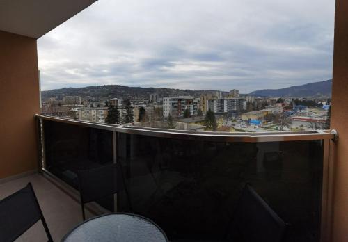 a balcony with chairs and a view of a city at Apartman Krasula Doboj in Doboj