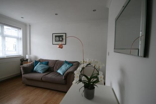 a living room with a couch and a table at Molesey near Hampton Court, Viking Short Stays in West Molesey