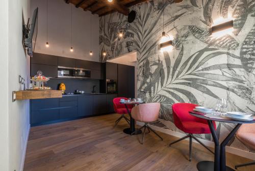 a dining room with red chairs and a wall at Residenza Benizzi rooms in the heart of Florence in Florence