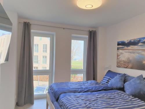 Postel nebo postele na pokoji v ubytování Apartment Ankerhuus, Am Alten Deich 6, Whg 1 18