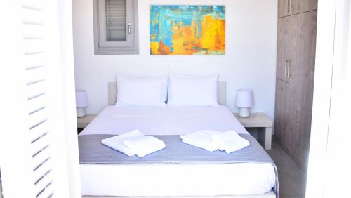 A bed or beds in a room at Antigoni Villas