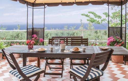 a wooden table and chairs on a patio at Baia Serena in Vico Equense