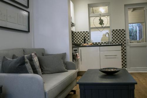 a living room with a couch and a table at Downshire Haven in Holywood