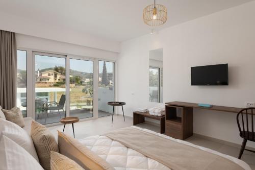 a living room with a couch and a tv on a wall at Nama Retreat in Pastida