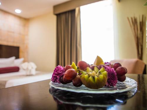 
a bowl of fruit sitting on top of a table at H177 Hotel in Campeche
