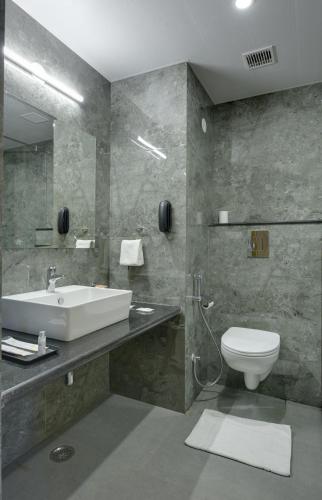 a bathroom with a sink and a toilet at Hotel khumani By Hills N Dunes in Udaipur