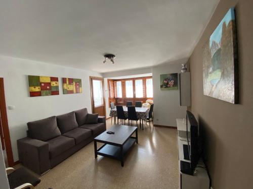 a living room with a couch and a table at El Puente in Boltaña