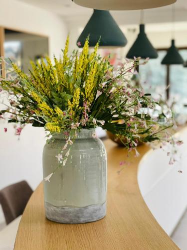a vase filled with flowers sitting on a table at Domaine Les Sources de Dieulefit in Dieulefit