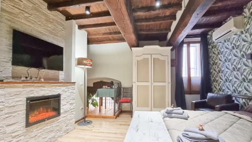 a living room with a couch and a fireplace at Residenza dei Longobardi Affittacamere in Spoleto