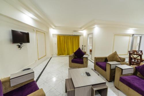 a living room with two couches and a tv at Zafero Studios and Apartments - Families only in Alexandria