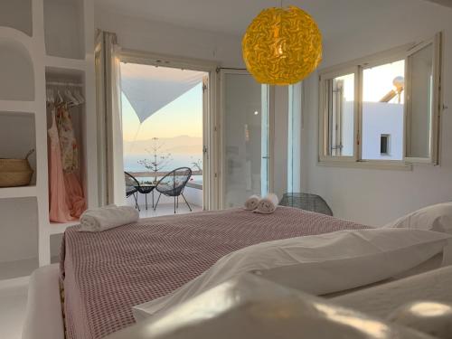 a bedroom with a bed with a view of the ocean at Heyblue Aura Seaside Villa - Unique escape in Naxos Chora