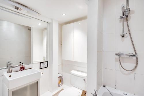a white bathroom with a sink and a toilet at Characterful & Cosy Jericho House (sleeps up to 8) in Oxford