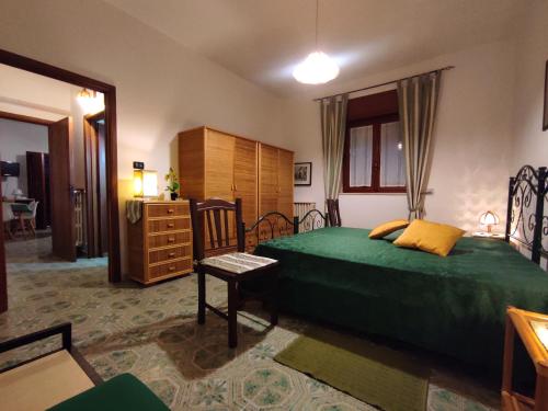 a bedroom with a green bed and a dresser at I colori di Otranto by CASASI Vacanze Otranto in Otranto