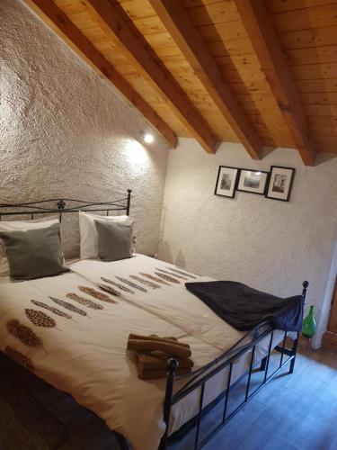 a bedroom with a large bed in a room at Rustico Lago di Como b&b in Barna