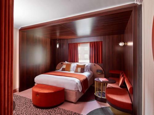 a hotel room with two beds and two lamps at MGallery Nest Paris La Défense Ex Sofitel in Puteaux