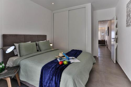 a bedroom with a bed with fruit on it at Lemon Tree Apartment in Luz