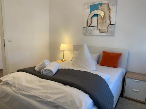 a bedroom with a bed with two towels on it at Time Out Apartments in Herzogenaurach