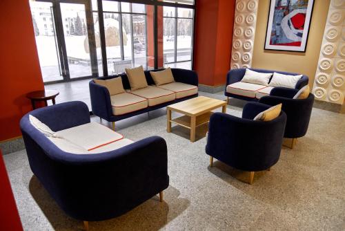 a waiting room with couches and chairs and a table at Отель KOKSHETAU in Kokshetau