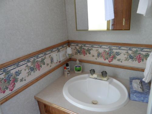 
a bathroom with a sink, toilet, and bathtub at Pahrump RV Park & Lodging in Pahrump

