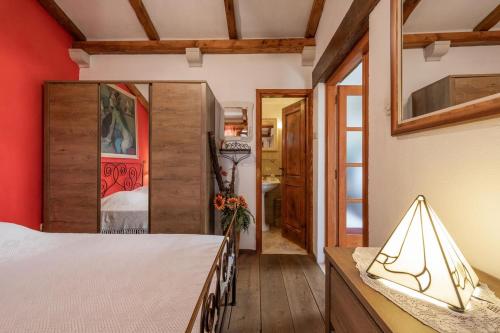 1 dormitorio con cama y pared roja en Holiday Home Tania, en Vela Luka
