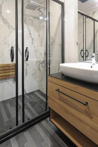 a bathroom with a sink and a shower at New Balturk Hotel Izmit in Kocaeli