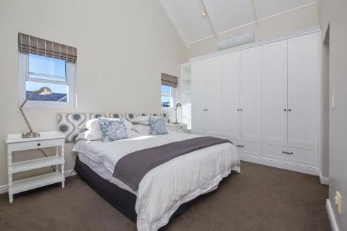 a bedroom with a large bed and a window at Thesen Island Holiday House in Knysna