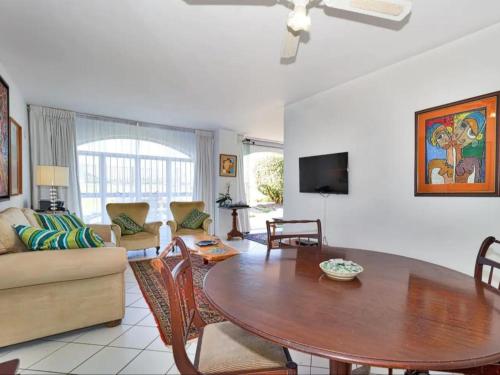 a living room with a table and a couch at Summerseas Units in Summerstrand