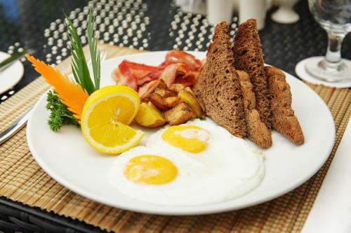 a plate of eggs and toast on a table at Villa Caemilla Beach Boutique Hotel in Boracay