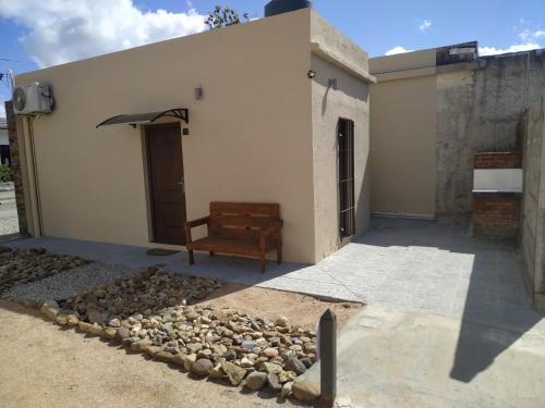 a building with a chair and a pile of rocks at Casita de Piedra in Trinidad
