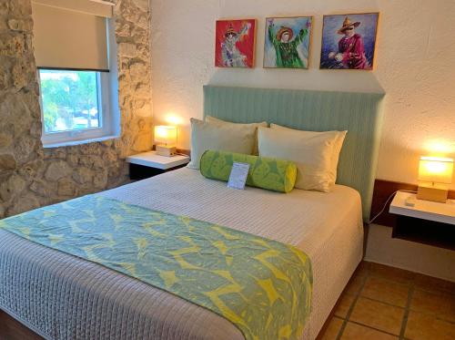 a bedroom with a large bed with two lamps at Sand Castle on the Beach - Adults Only in Frederiksted