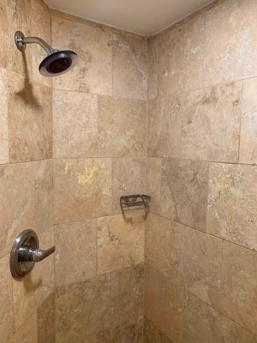a bathroom with a shower with a glass door at Sand Castle on the Beach - Adults Only in Frederiksted