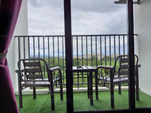 a table and chairs on a balcony with a view at Maz Stayhouse in Alor Setar