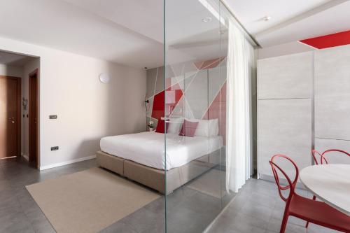 a bedroom with a bed and a glass wall at Hotel Borgo Brianteo in Ponte San Pietro