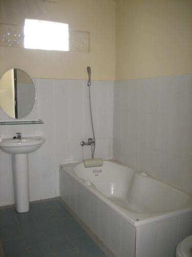 a bathroom with a bath tub and a sink at Lucky Paradise Bungalows on The Beach in Amed