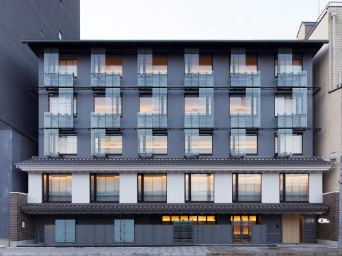 an external view of a building with many windows at hotel androoms Kyoto Shichijo in Kyoto