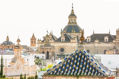 a view of a large building with turrets at Aquitania Home Suites in Seville