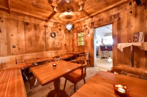 a dining room with wooden walls and tables at STADT HOTEL Iserlohn in Iserlohn
