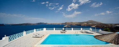 a swimming pool with a view of the water at Villa Maria Apartments in Akrotiri