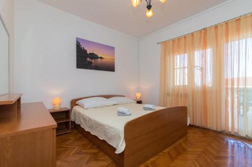 a bedroom with a bed and a large window at Apartments Spirit of the Sea in Tkon