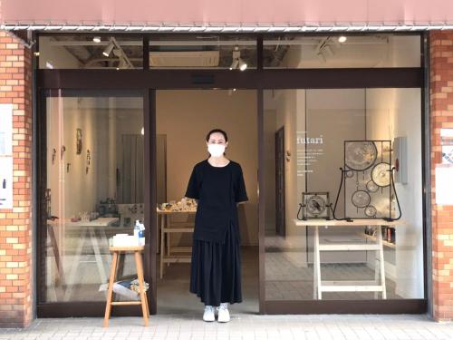 a woman wearing a mask in a store window at Gallery House in Tokyo